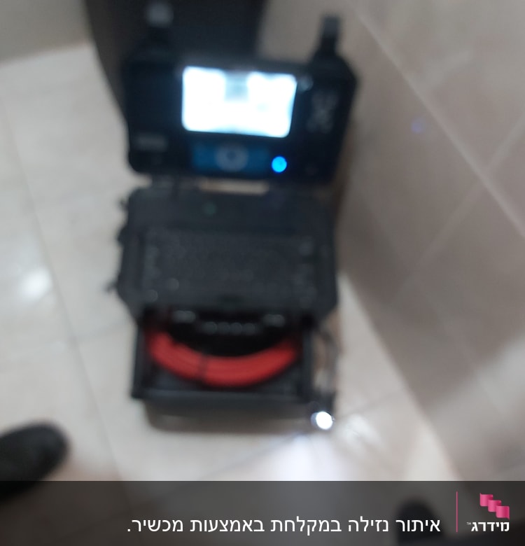 מחשב נייד עם מסך מואר וכבל אדום